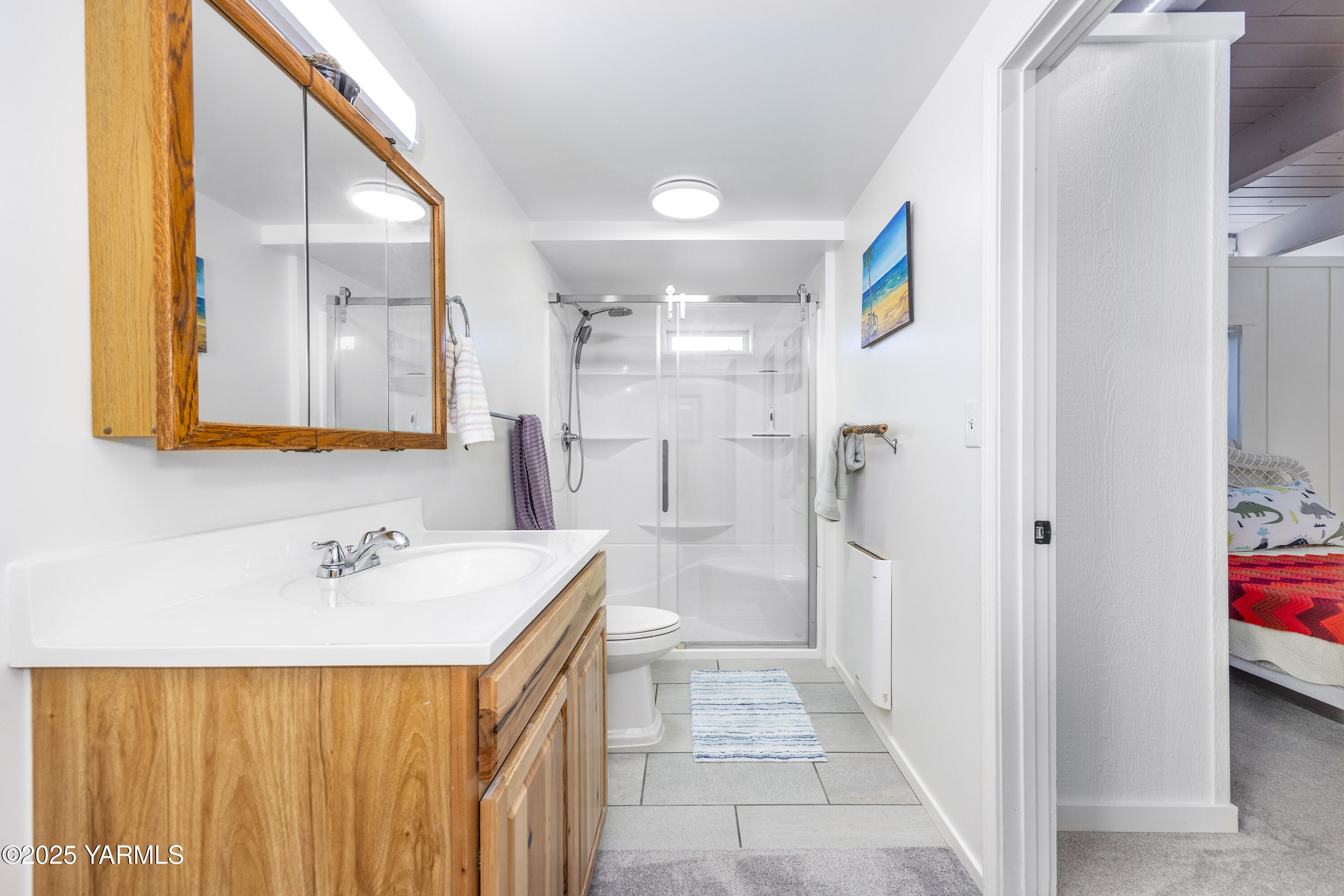 22207 West Gerrick Road Benton City, WA 99320 - Photo 33 of 60 a spacious bathroom with a sink a shower and a mirror