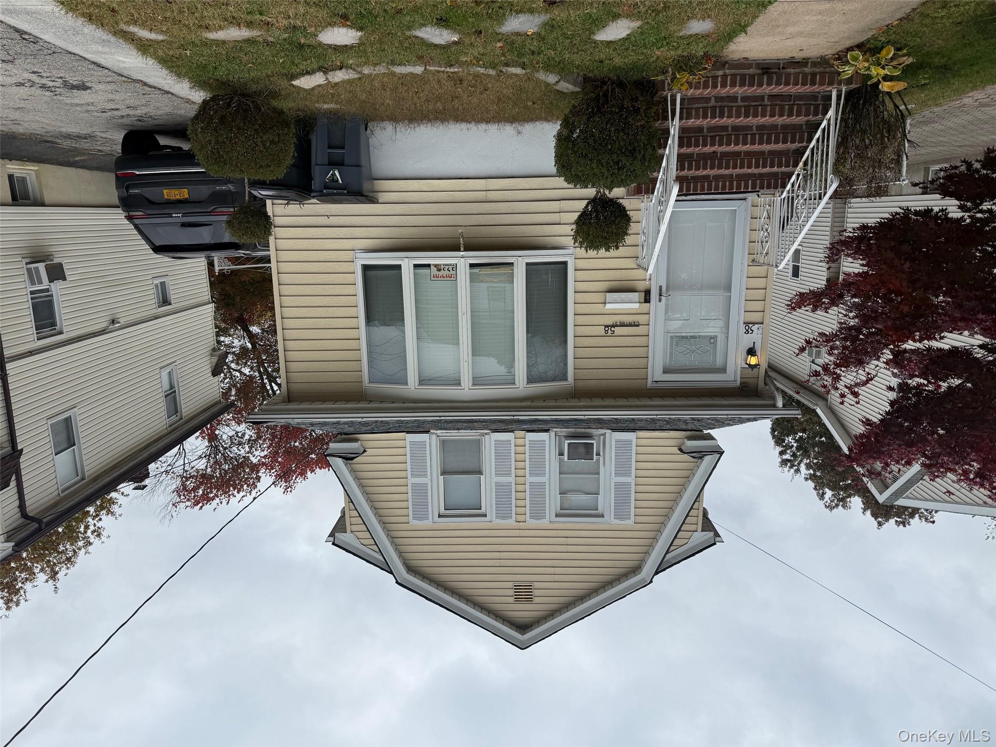 Dutch colonial with a gambrel roof and a shingled roof