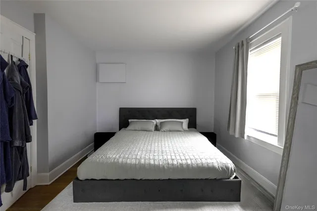 a large bed sitting in a bedroom next to a window