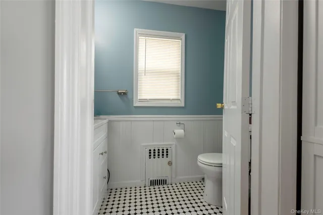 a bathroom with a toilet a window and a shower