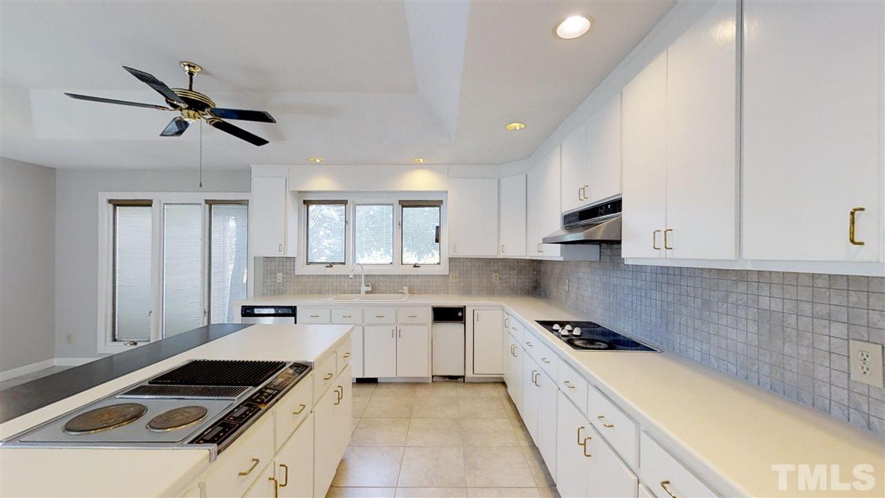 913 Windrow Lane Raleigh, NC 27603 - Photo 12 of 25 a kitchen that has a sink and a stove in it