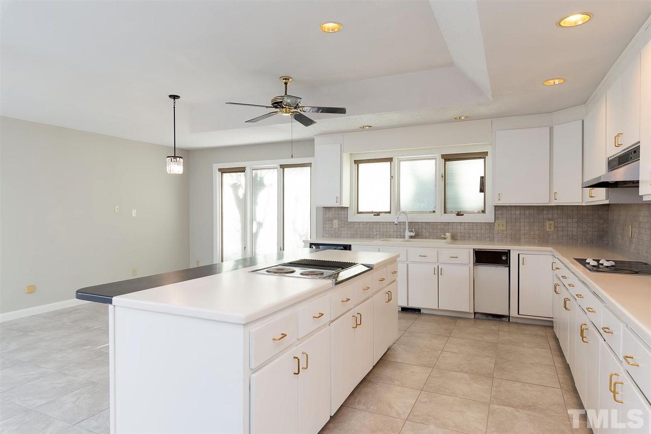 913 Windrow Lane Raleigh, NC 27603 - Photo 14 of 25 a kitchen with granite countertop white cabinets white stainless steel appliances with a sink and dishwasher