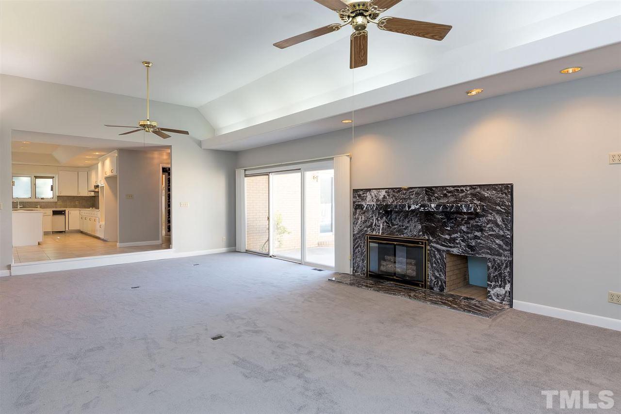 913 Windrow Lane Raleigh, NC 27603 - Photo 15 of 25 a view of a livingroom with a fireplace and window
