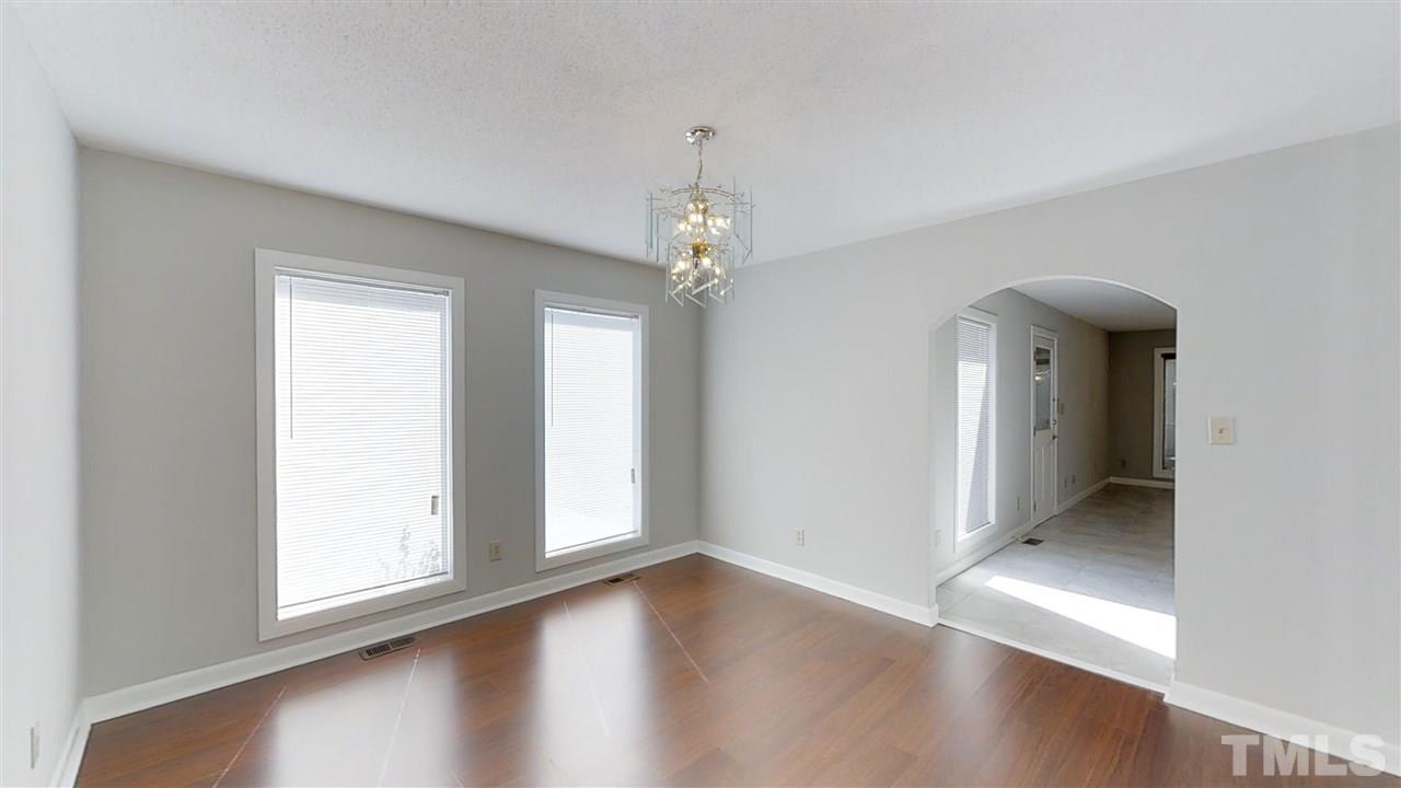 913 Windrow Lane Raleigh, NC 27603 - Photo 18 of 25 wooden floor in an empty room with a window
