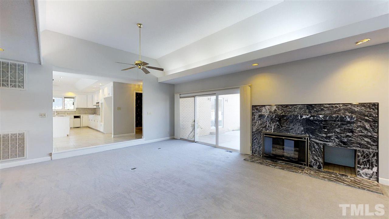 913 Windrow Lane Raleigh, NC 27603 - Photo 19 of 25 a view of a livingroom with a fireplace and a window