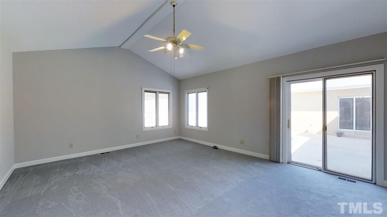 913 Windrow Lane Raleigh, NC 27603 - Photo 21 of 25 an empty room with chandelier fan and windows