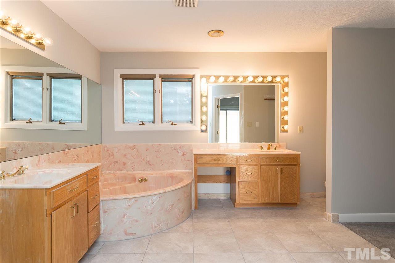 913 Windrow Lane Raleigh, NC 27603 - Photo 24 of 25 a bathroom with a bathtub a sink and a window