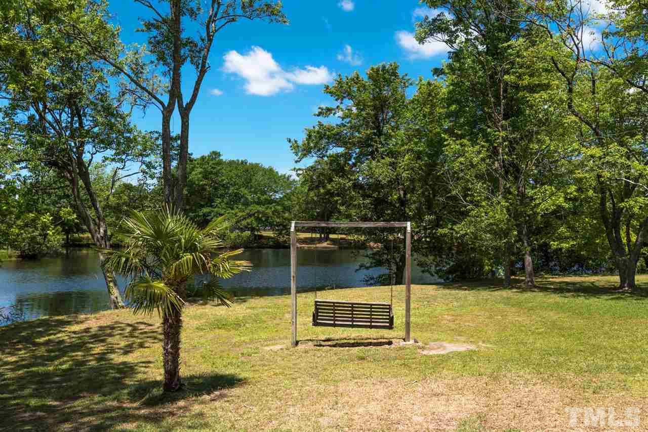 913 Windrow Lane Raleigh, NC 27603 - Photo 8 of 25 a wooden fence with lake view