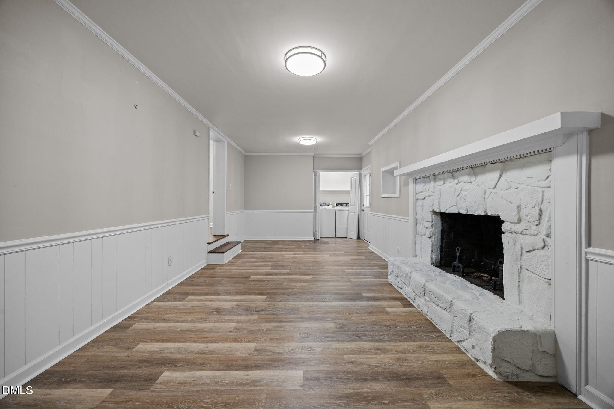 2950 Glenridge Drive Raleigh, NC 27604 - Photo 27 of 53 a view of an empty room with wooden floor and a fireplace