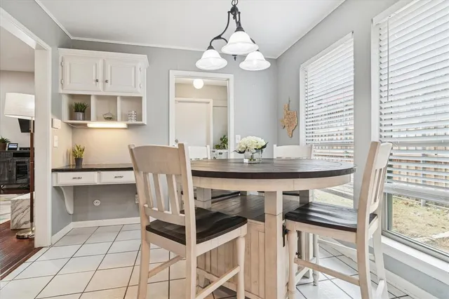 a dining room with furniture and window