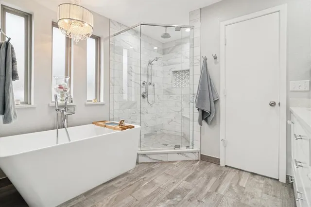 a bathroom with a tub a sink and a shower