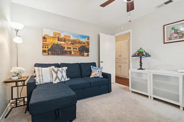 a living room with furniture and a potted plant