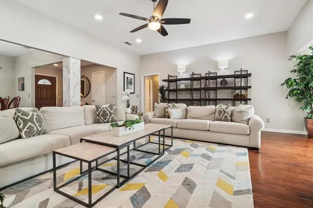 a living room with furniture and wooden floor