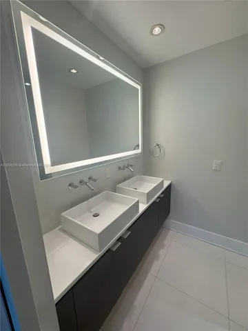 a bathroom with a double vanity sink and mirror