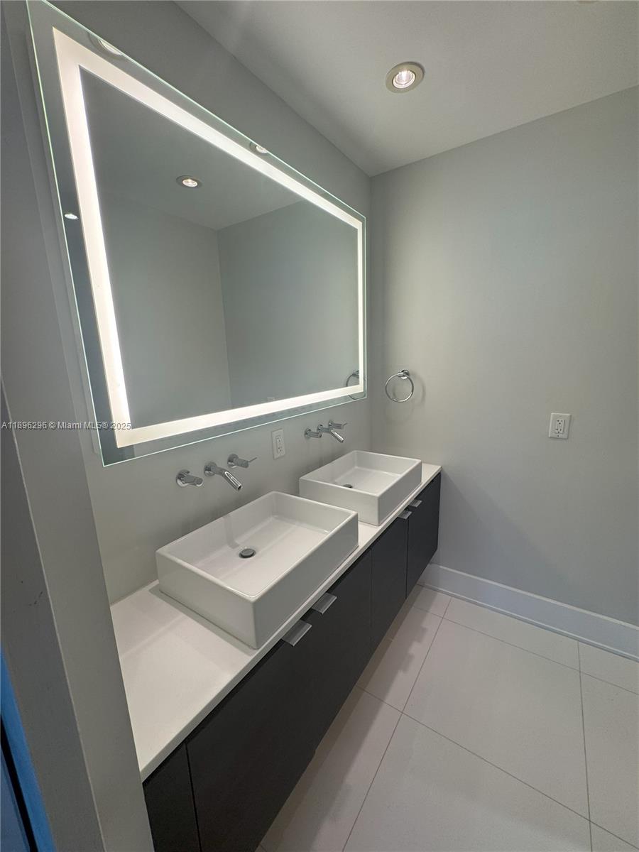 5970 Indian Creek Drive, Unit PH3 Miami Beach, FL 33140 - Photo 17 of 37 a bathroom with a double vanity sink and mirror