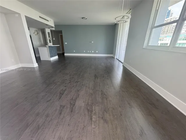 a view of a livingroom with wooden floor and stairs