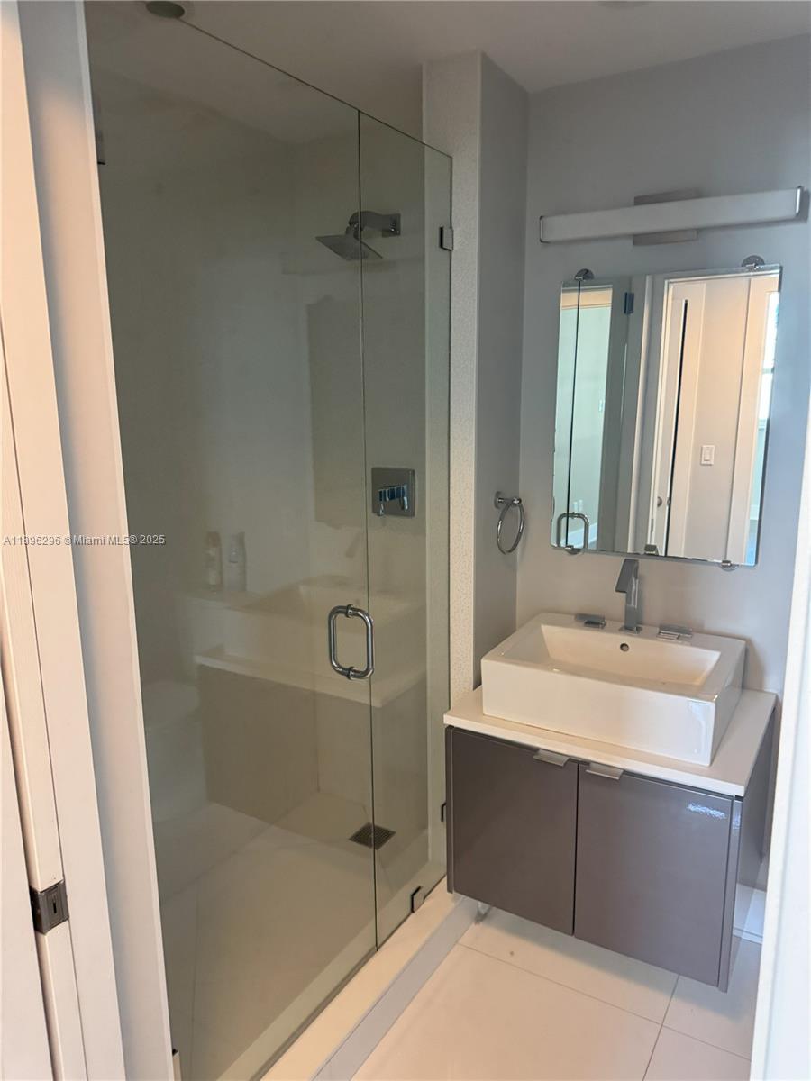 5970 Indian Creek Drive, Unit PH3 Miami Beach, FL 33140 - Photo 23 of 37 a bathroom with a sink and a mirror