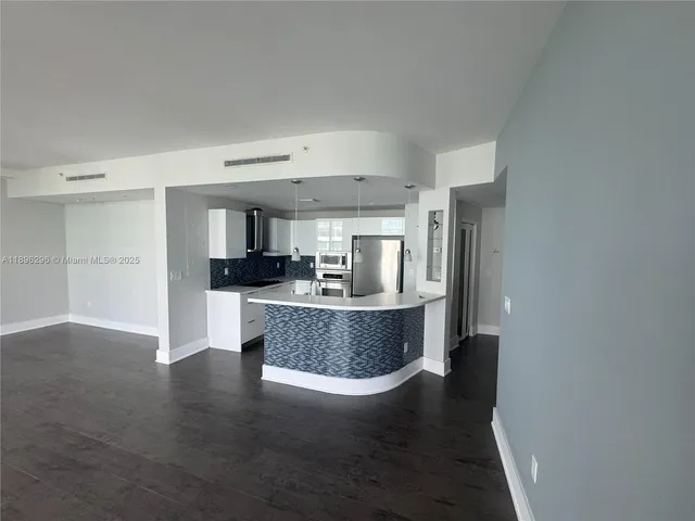 a view of kitchen and dining room with wooden floor