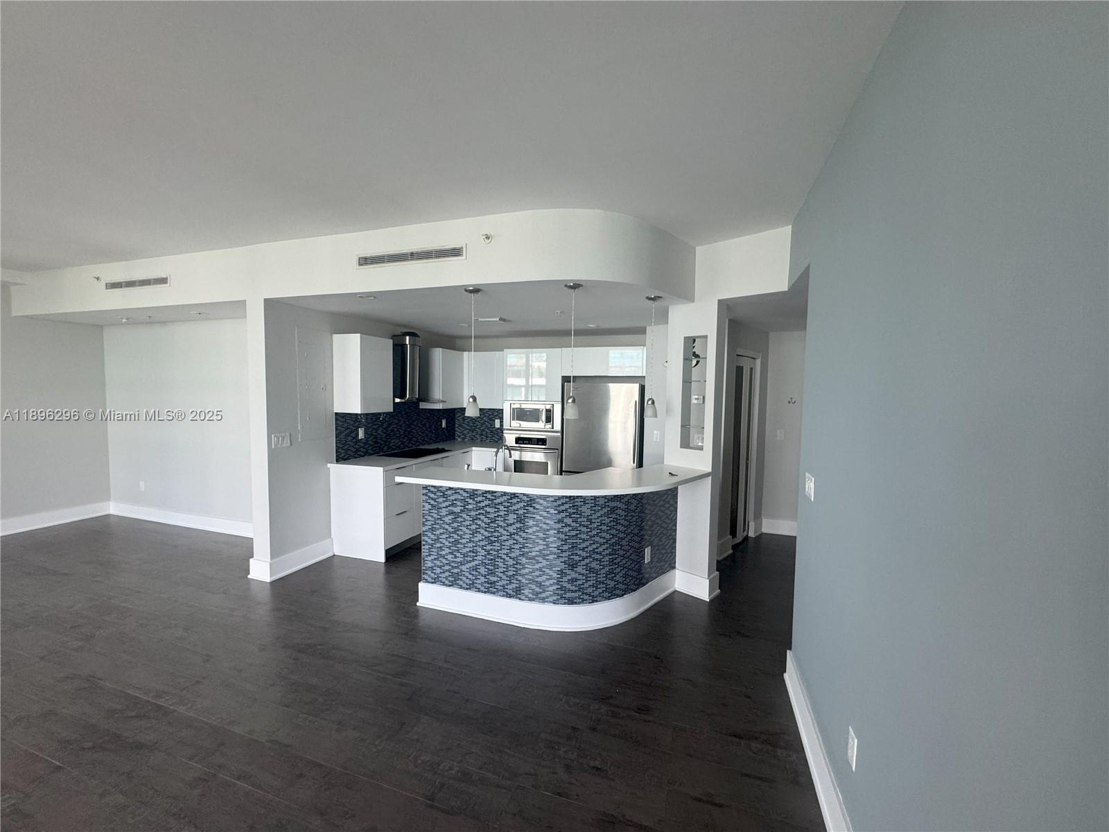 5970 Indian Creek Drive, Unit PH3 Miami Beach, FL 33140 - Photo 5 of 37 a view of kitchen and dining room with wooden floor