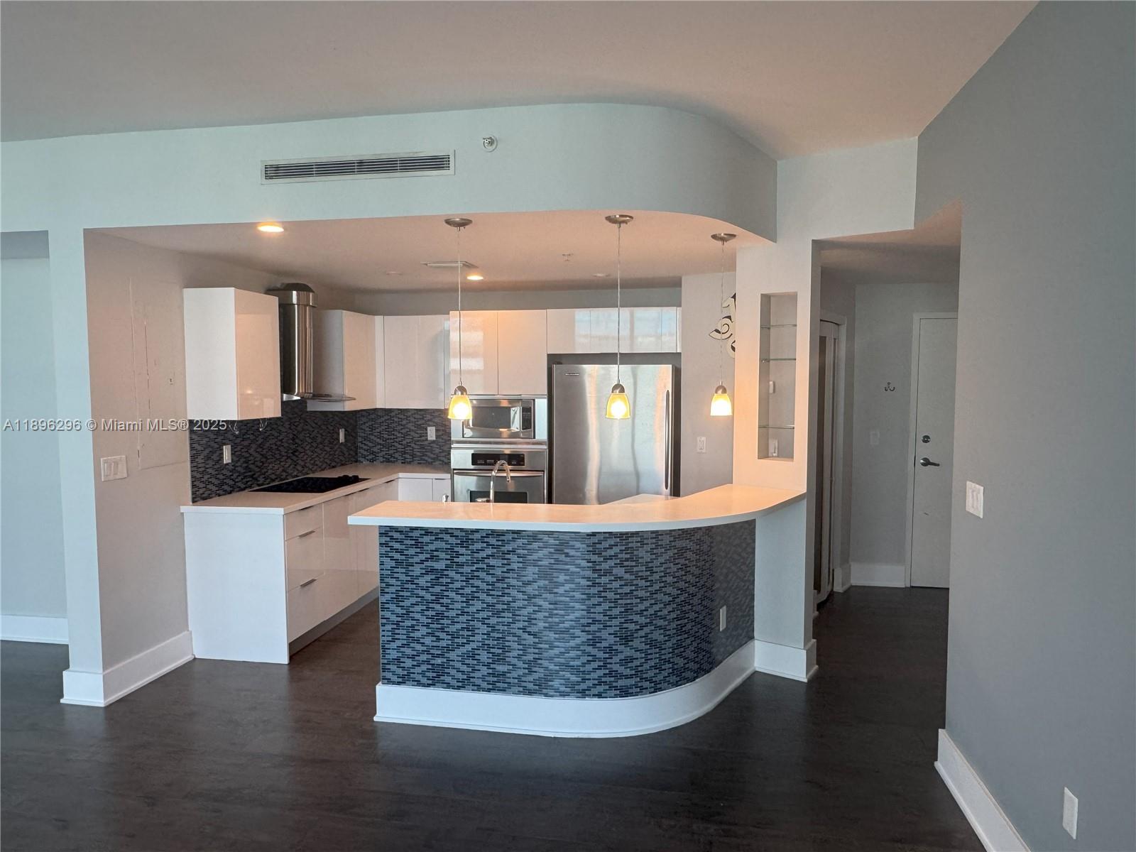 5970 Indian Creek Drive, Unit PH3 Miami Beach, FL 33140 - Photo 6 of 37 a living room with a couch and wooden floor