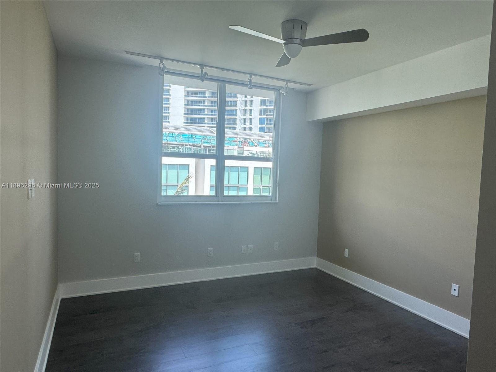 5970 Indian Creek Drive, Unit PH3 Miami Beach, FL 33140 - Photo 9 of 37 an empty room with wooden floor and windows