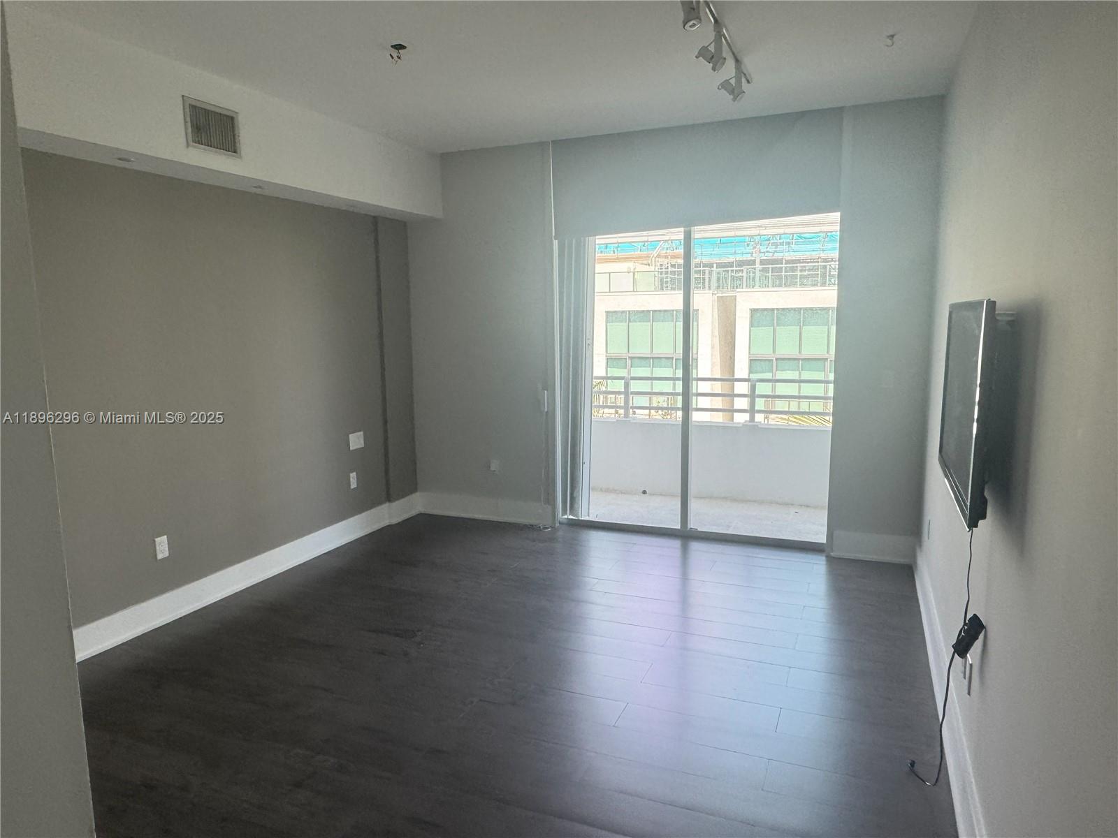 5970 Indian Creek Drive, Unit PH3 Miami Beach, FL 33140 - Photo 10 of 37 wooden floor in an empty room with a window