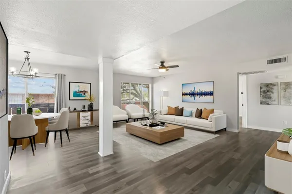 a living room with furniture and a wooden floor