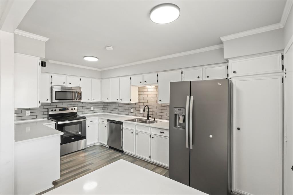 10526 Stone Canyon Road, Unit 201 Dallas, TX 75230 - Photo 2 of 28 a kitchen with stainless steel appliances granite countertop a refrigerator and a stove top oven