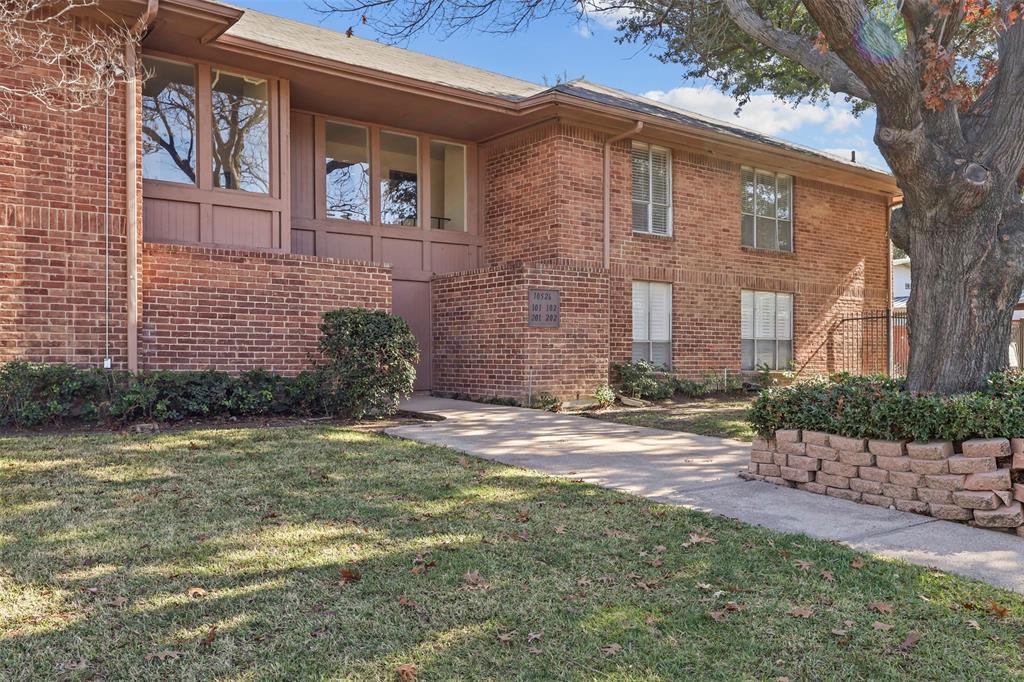 10526 Stone Canyon Road, Unit 201 Dallas, TX 75230 - Photo 24 of 25 a front view of a house with a garden