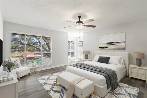 a bedroom with a large bed and a large window