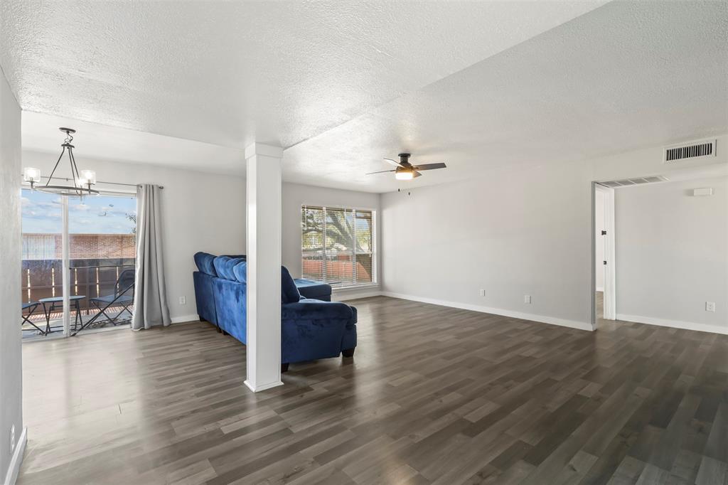 10526 Stone Canyon Road, Unit 201 Dallas, TX 75230 - Photo 4 of 28 a view of a livingroom with wooden floor and a kitchen space with a sink