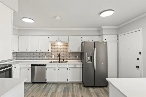 a kitchen with a sink a refrigerator and a stove