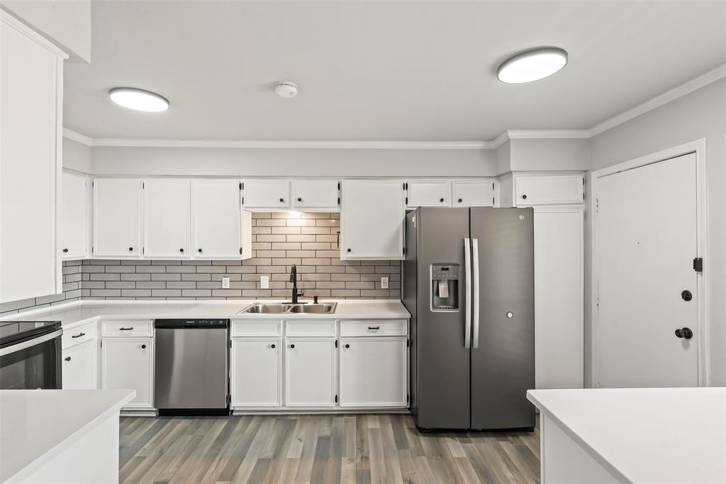 10526 Stone Canyon Road, Unit 201 Dallas, TX 75230 - Photo 6 of 25 a kitchen with a sink a refrigerator and a stove