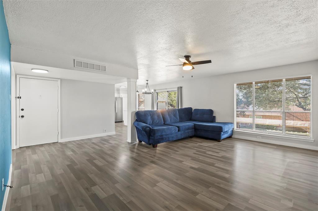 10526 Stone Canyon Road, Unit 201 Dallas, TX 75230 - Photo 7 of 28 a living room with furniture and a large window