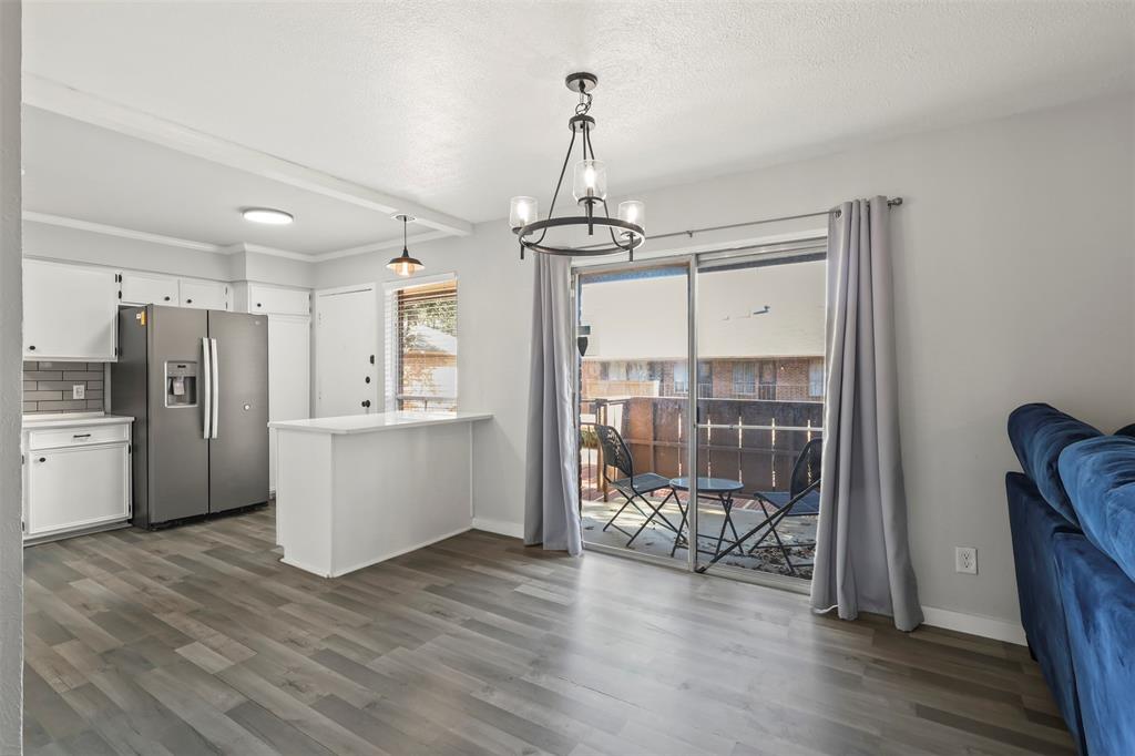 10526 Stone Canyon Road, Unit 201 Dallas, TX 75230 - Photo 9 of 28 a view of a kitchen with refrigerator and wooden floor