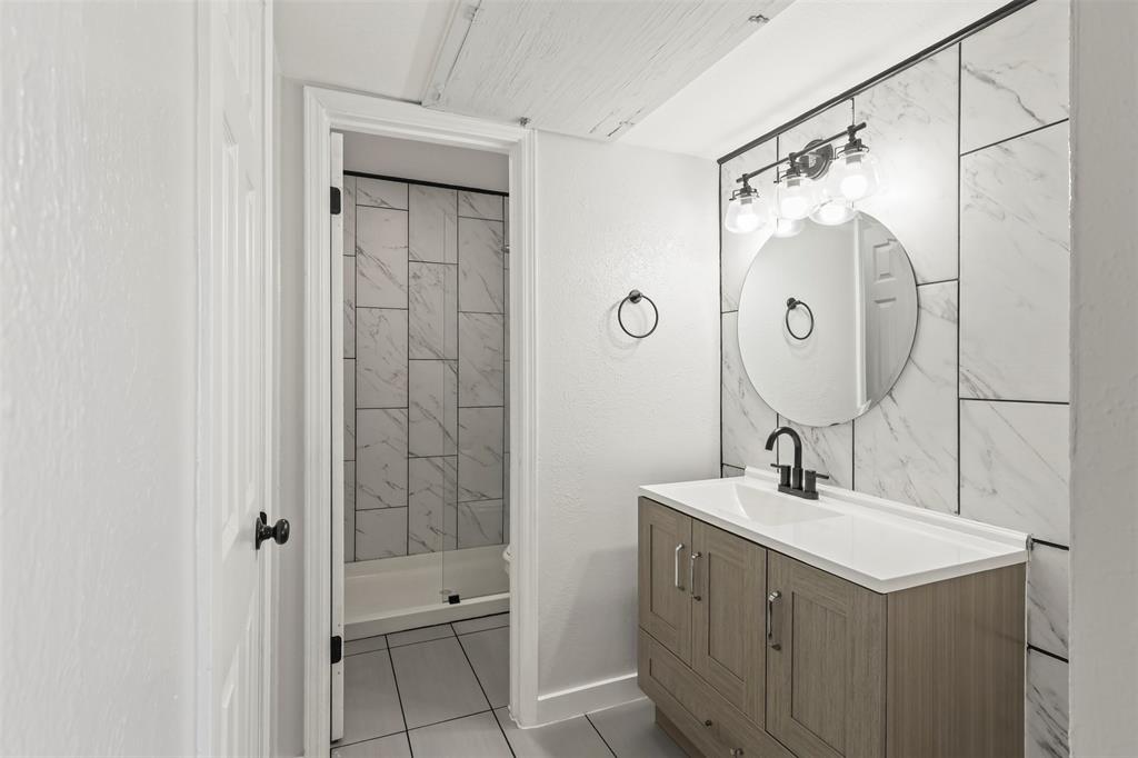 10526 Stone Canyon Road, Unit 201 Dallas, TX 75230 - Photo 10 of 25 a bathroom with a double vanity sink mirror and shower