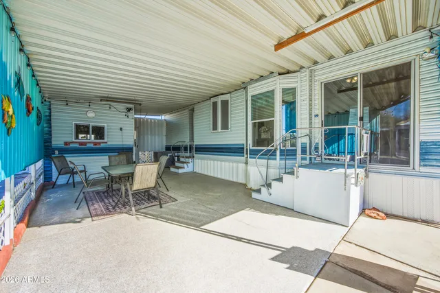 a backyard of a house with a yard and seating space