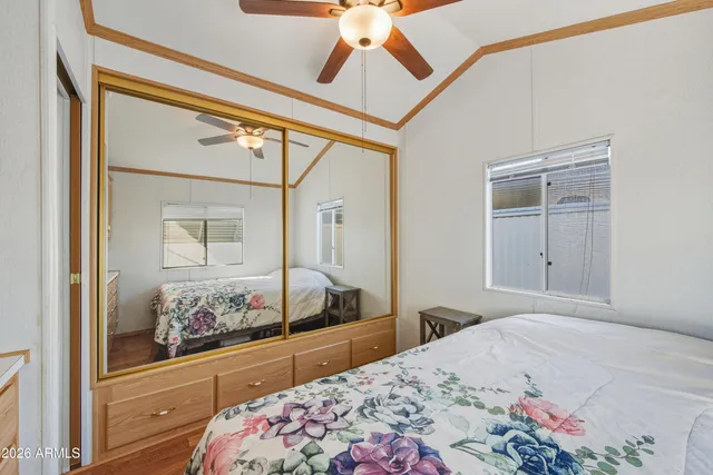 a living room with stainless steel appliances furniture and a kitchen view