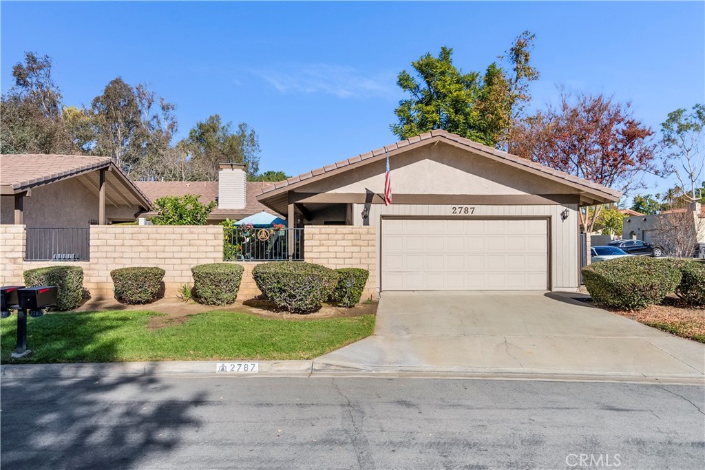 2787 Persimmon Place Riverside, CA 92506 - Photo 1 of 1 a front view of a house with a yard and garage