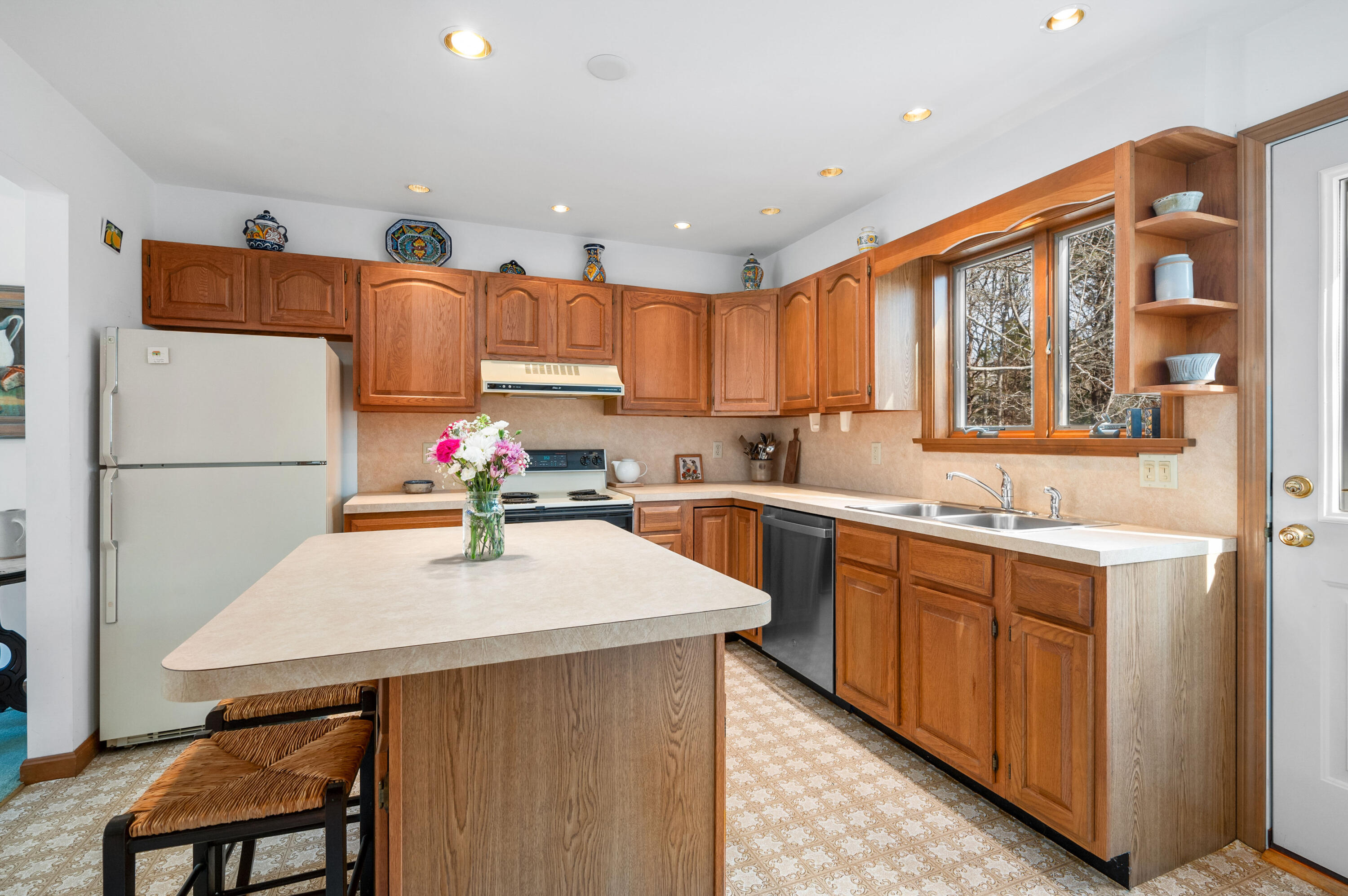 55 Bow Road Eastham, MA 02642 - Photo 13 of 44 a kitchen with a sink a stove a refrigerator and white cabinets