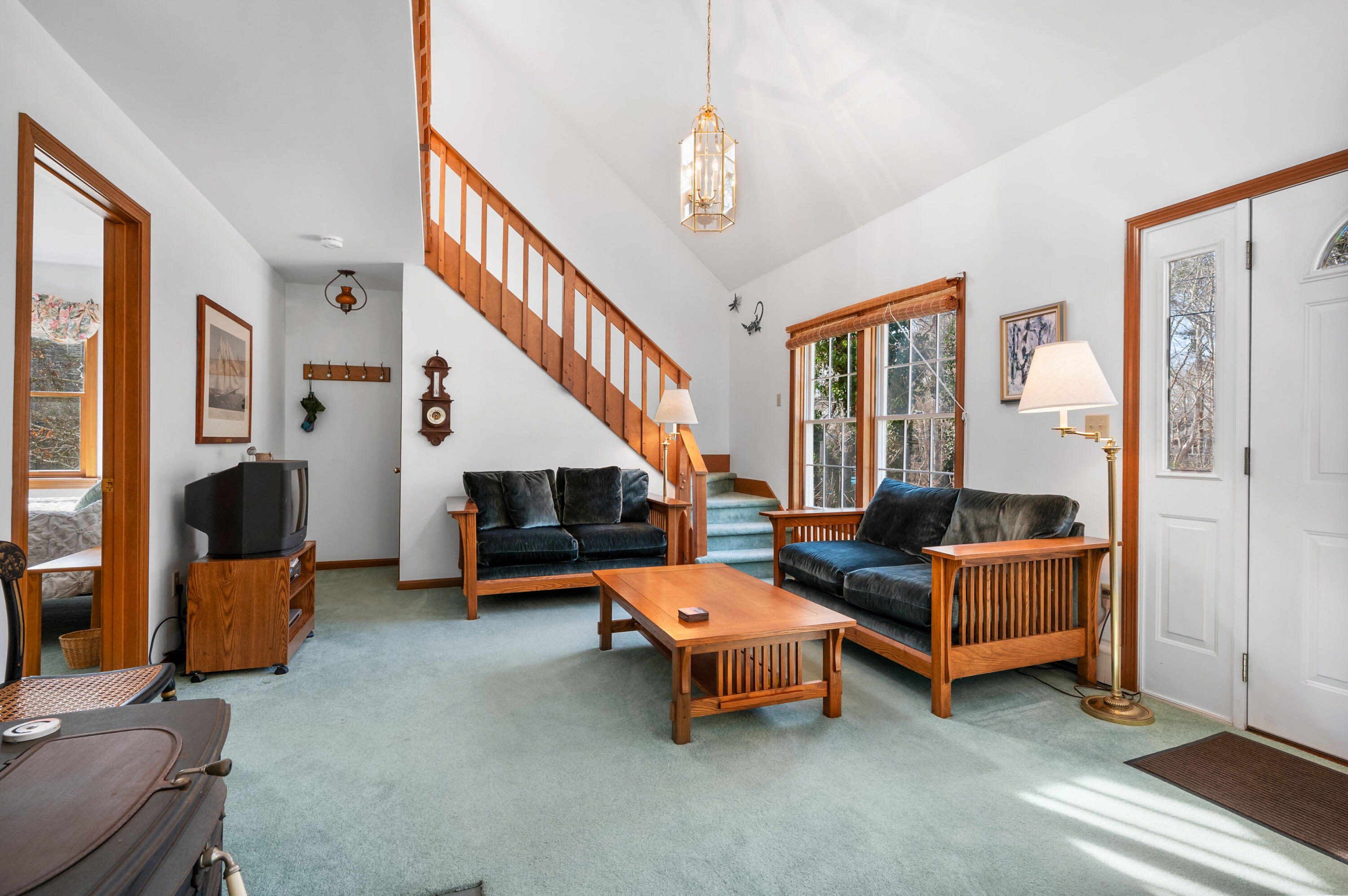 55 Bow Road Eastham, MA 02642 - Photo 20 of 44 a living room with furniture and a chandelier