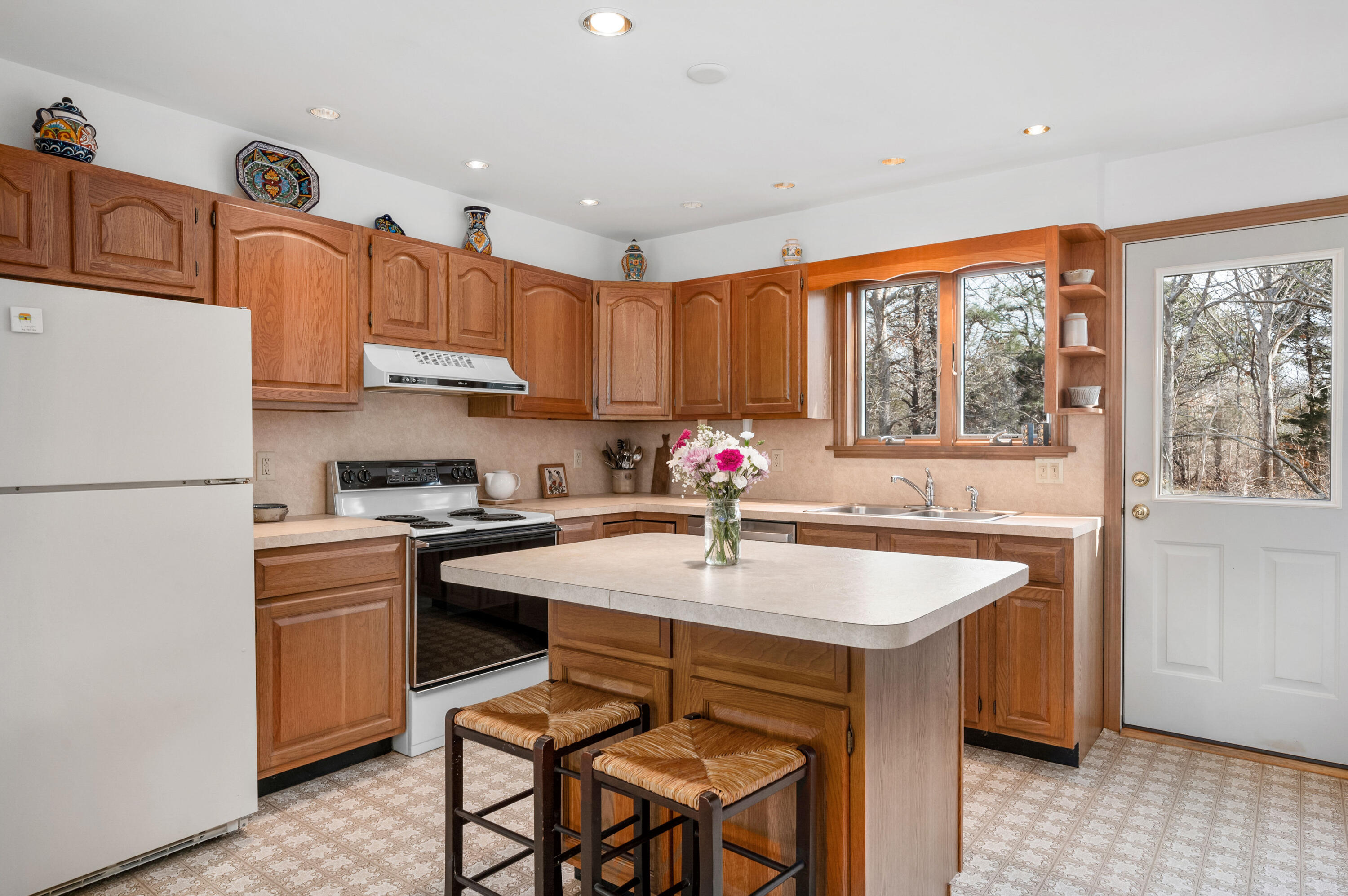 55 Bow Road Eastham, MA 02642 - Photo 10 of 44 a kitchen with stainless steel appliances granite countertop a stove a sink dishwasher and a refrigerator