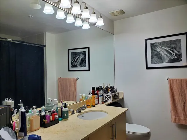 a view of a workspace with furniture and a bathroom