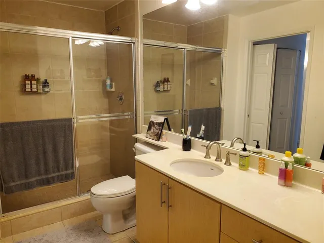 a bathroom with a sink toilet and shower