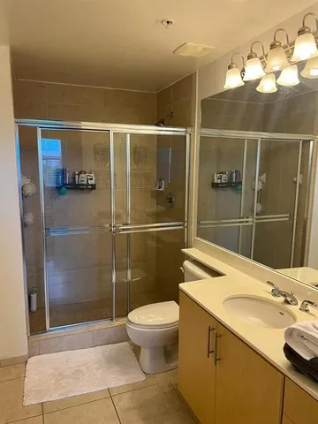 a bathroom with a sink a toilet and shower