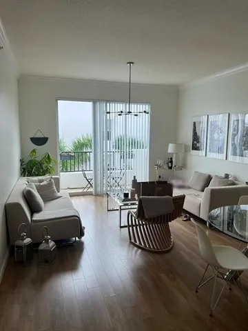 a living room with furniture rug and a large window