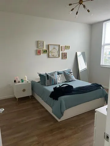 a spacious bedroom with a bed and window