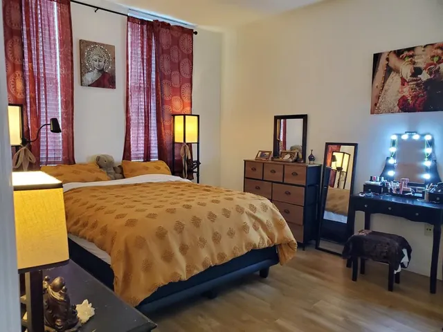 a bed sitting in a bedroom next to a window