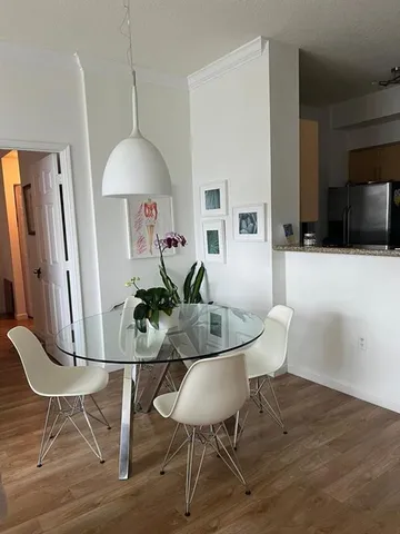 a living room with furniture a flat screen tv and a table