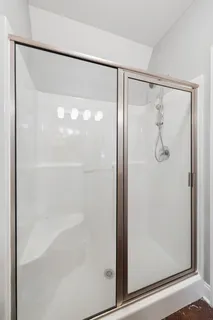 a bathroom with a glass shower door